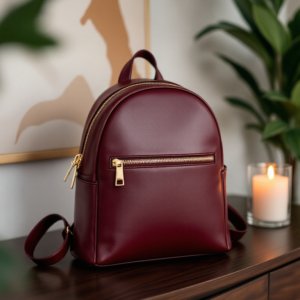 red mini leather backpack on a table